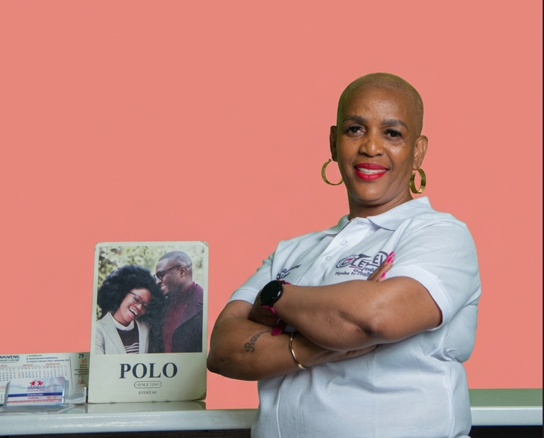 Menge Moiloa, the optometrist at Mahikeng Medical Center, in a white polo shirt with the Lewele logo, arms crossed